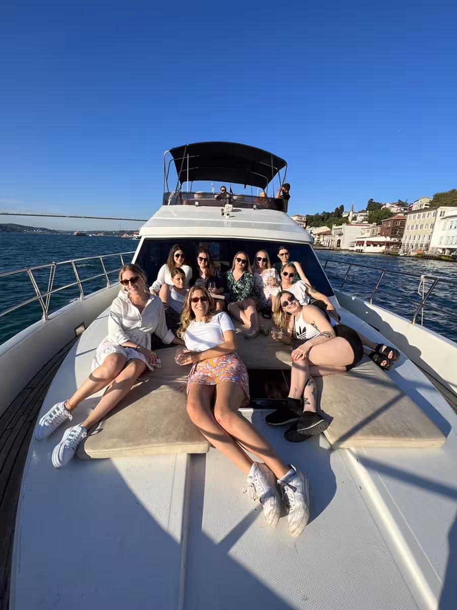 Group sunbathing on the bow during a private Istanbul Bosphorus yacht tour with swimming breaks and skyline views