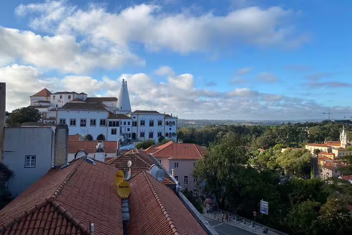 Scenic view of Sintra's historic architecture and lush landscape on a sunny day during a private Jeep tour.