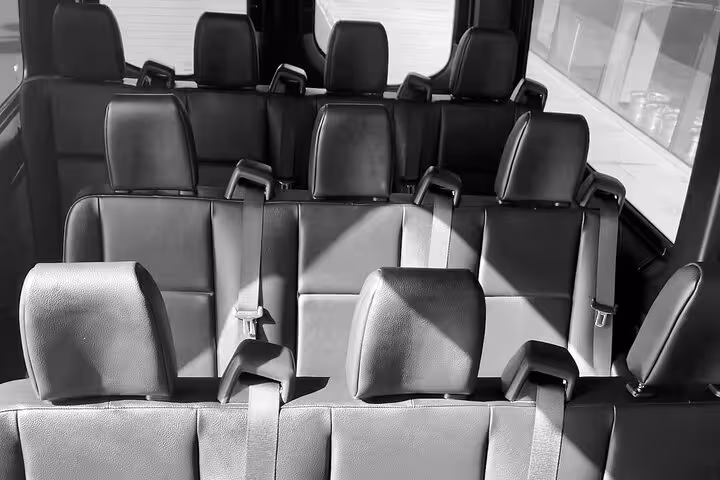 Spacious interior of a private KOA airport transfer van with comfortable seating for a smooth island welcome ride.