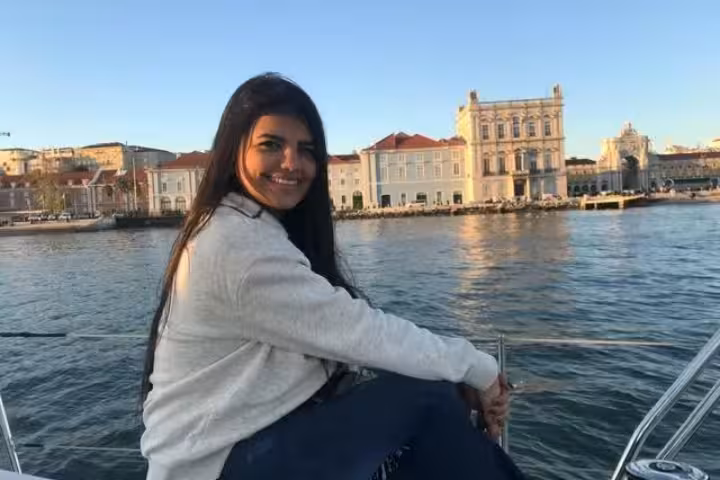 Guest relaxing on a private Lisbon sightseeing cruise on the Tagus River with Belém waterfront in view