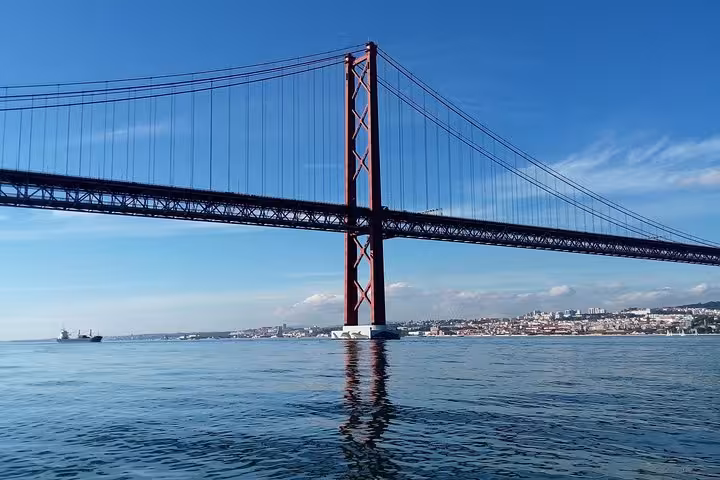 Private Lisbon sailing cruise passing under the 25 de Abril Bridge on the Tagus River with city views