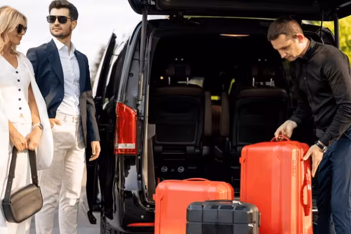 Private Luxor to Aswan van transfer with driver loading luggage, ideal for couples and small groups