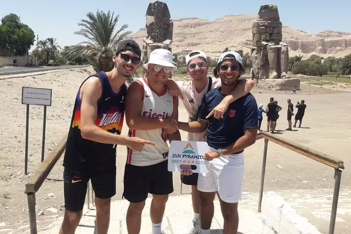 Travelers at Colossi of Memnon on a private Luxor day tour from Cairo by flight, Egypt highlights