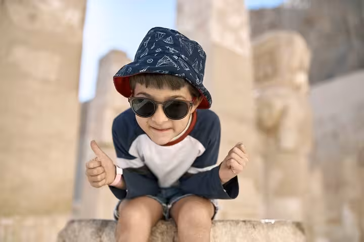 Family-friendly private Luxor day tour with flexible itinerary, traveler at ancient temple ruins in Egypt
