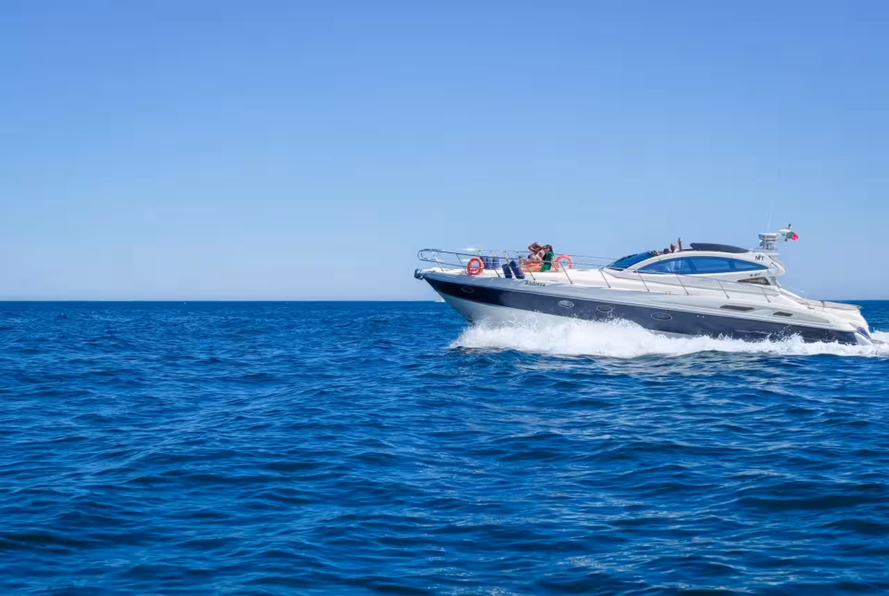 Luxury private yacht cruising the open Atlantic Ocean on a full-day boat tour departing from Albufeira Algarve.
