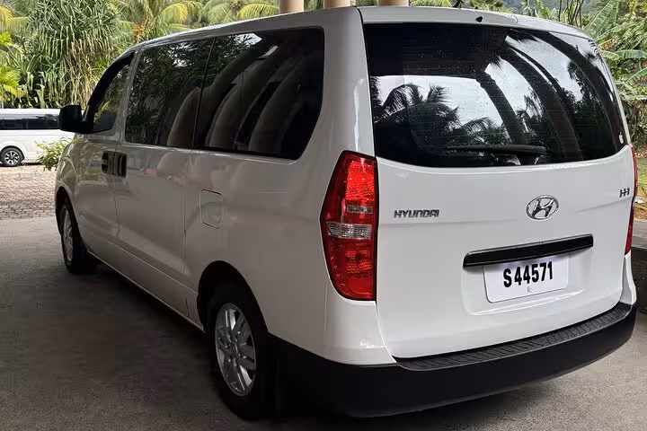 Comfortable white tour van ready for private excursions around Mahe Island's scenic routes.