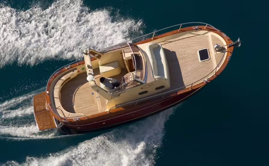 Elegant private motorboat cruising between Capri and Ischia, offering fast luxury transfer across the Bay of Naples