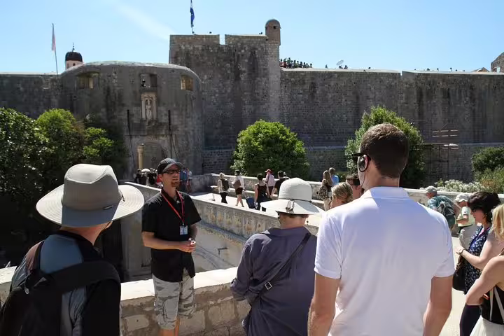 Private Old Town walking tour guide briefing guests on a bridge with panoramic views of the medieval city walls