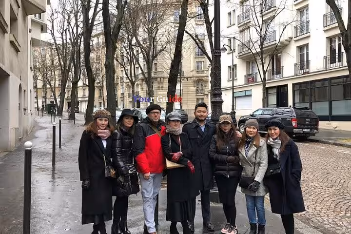 Group of tourists posing on a Parisian street during a private guided tour of Paris in winter