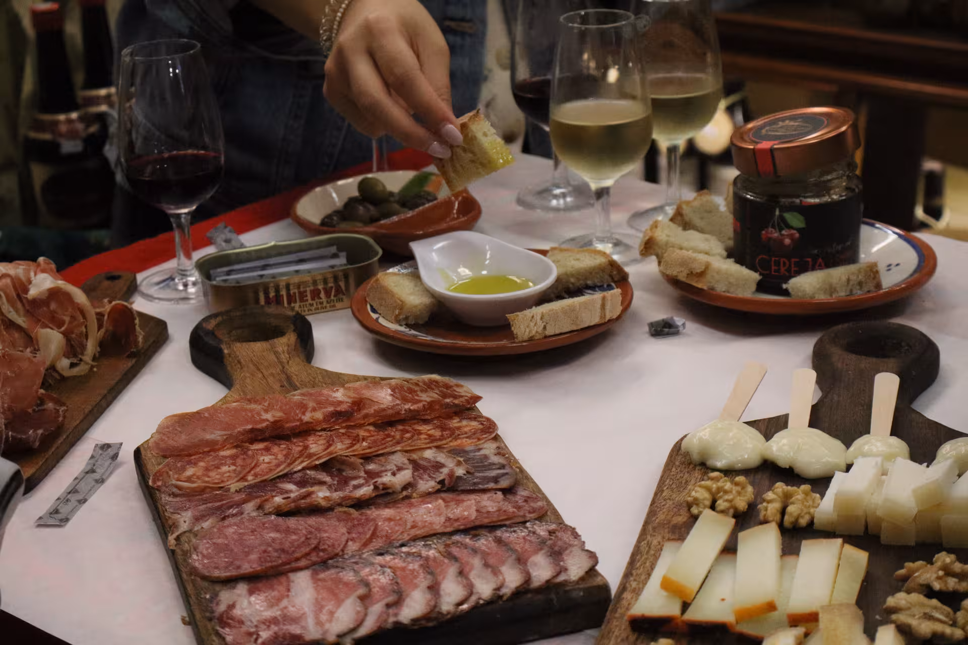 Private Porto food tour tasting charcuterie, local cheeses, olives and wine at a traditional Portuguese table