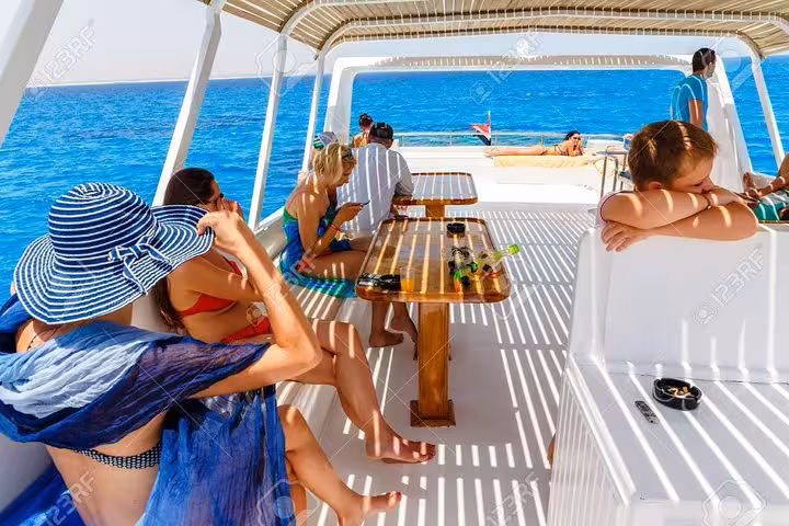 Guests relaxing on a private Red Sea boat deck near Hurghada, perfect for Sahl Hasheesh day cruise