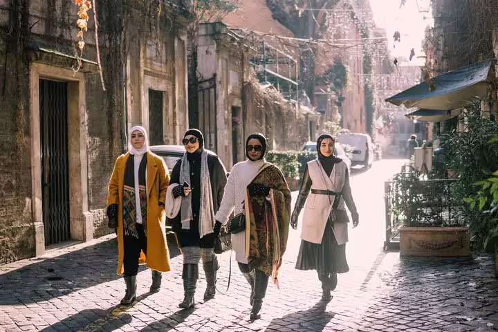 Friends walking a sunlit Rome cobblestone lane, captured on a private personal Rome travel photographer tour