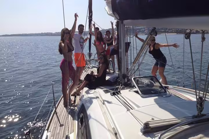 Group enjoying a sunny private sailing tour in Lisbon, capturing the vibrant atmosphere of a two-hour sea adventure.