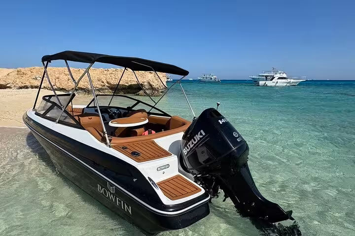 Private sea taxi moored in shallow turquoise water near Giftun Islands, Hurghada Red Sea excursion