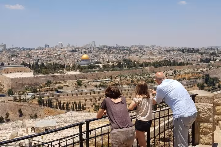 White private sedan for Tel Aviv to Jerusalem and Bethlehem day tour, scenic Jerusalem Old City background