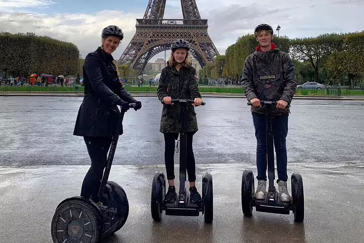 Private Segway tour in Paris with local guide near the Eiffel Tower, three riders on a rainy day