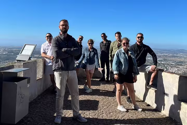 Group of tourists enjoying panoramic views during a private Sintra tour from Lisbon, visiting Pena and Regaleira Palaces.