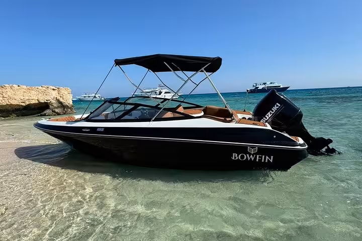 Private speedboat anchored in clear Red Sea water near Hurghada, ideal for Hula Hula Island snorkeling trip