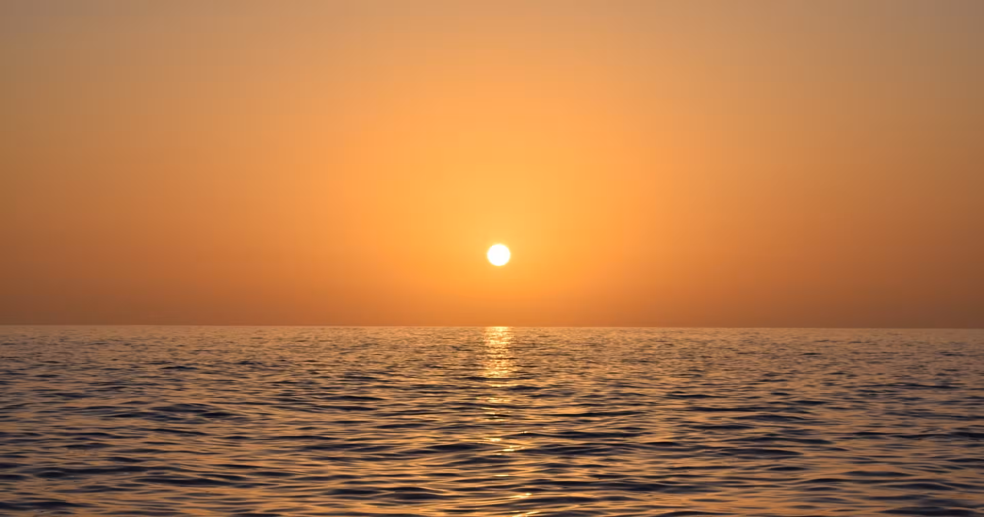 Beautiful sunset over the calm ocean, perfect for a serene private cruise experience.