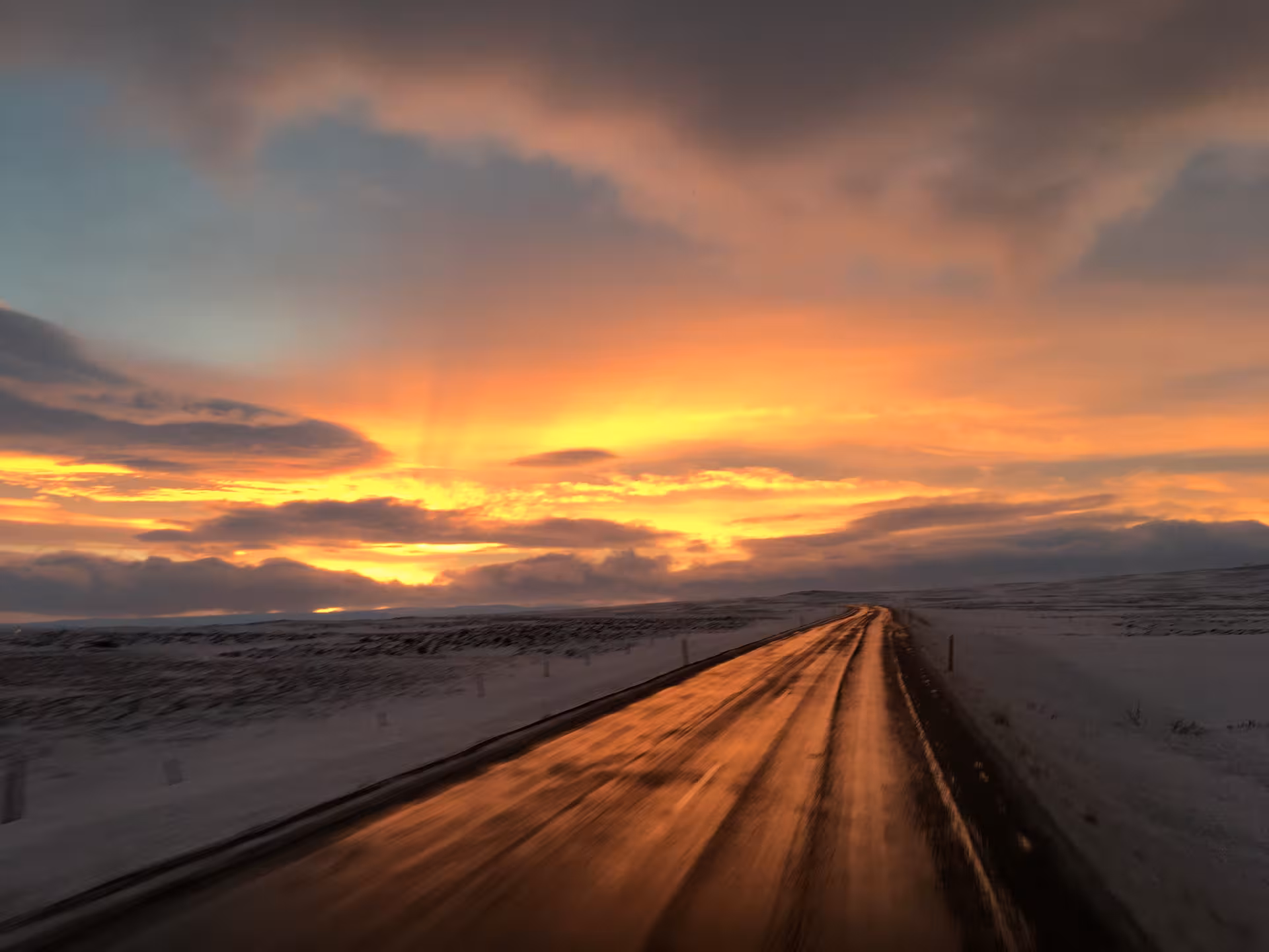 Scenic winter road at sunset, ideal for private tailor-made tour along snow-covered landscapes.