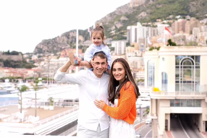 Happy family enjoying a private tour in Nice with scenic cityscape backdrop, capturing joyful moments with a travel photographer.