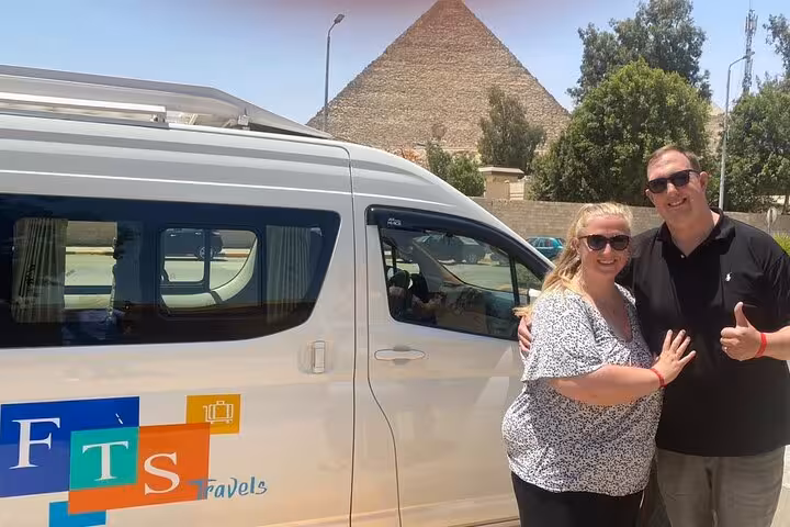 Private tour van pickup at Giza Pyramids, guests ready for 4-day private Cairo tour with guided transfers