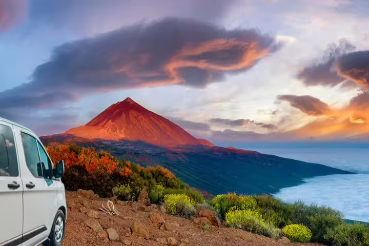 Private tour van parked near Mount Teide at sunset, offering stunning views of the volcanic landscape in Tenerife.