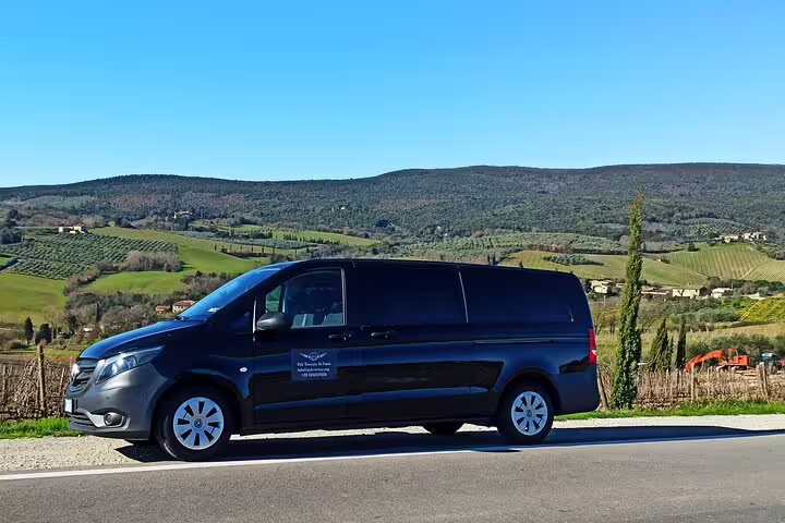 Comfortable private tour van parked in the rolling Chianti countryside on a Pisa and Tuscany wine tasting day trip