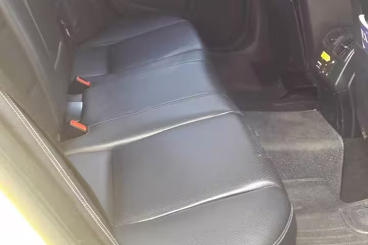 Spacious rear leather seats in private car transfer from Athens to Meteora Kalabaka for a comfortable journey