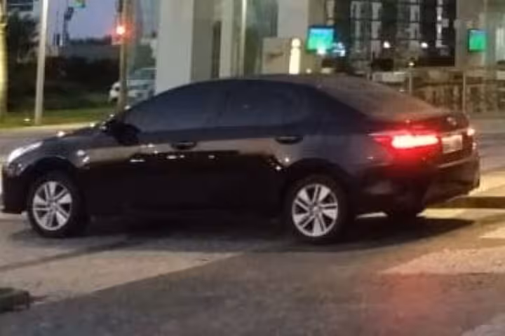Sleek black sedan offering comfortable private transfers from Guarulhos Airport to hotels in São Paulo.