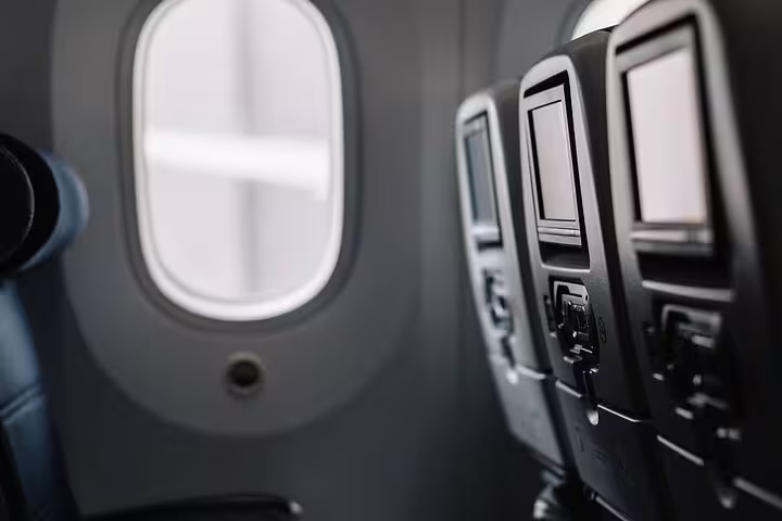 Airplane cabin seats by window after landing at Madrid Barajas, connect with private transfer to Madrid downtown