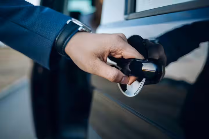Hand opening car door for a private transfer from Marco Polo airport to Venice cruise terminal.