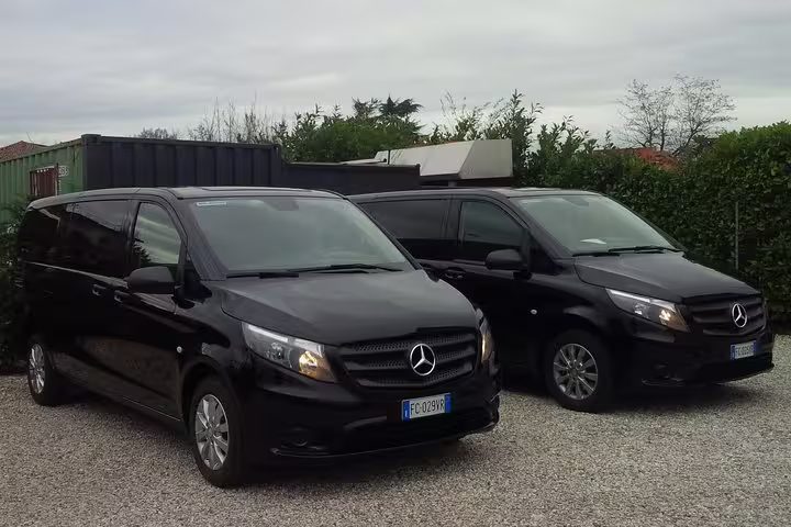 Two sleek black Mercedes vans ready for private transfer service from Marco Polo airport to Venice cruise port.
