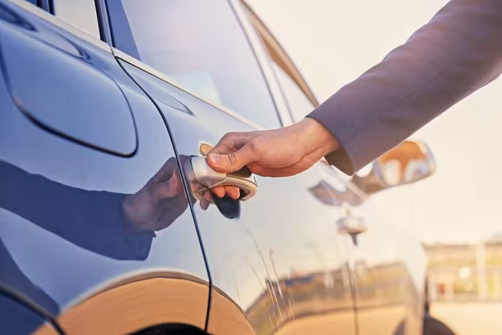 Close-up of driver opening car door for Marsa Alam to Hurghada private transfer with modern vehicle