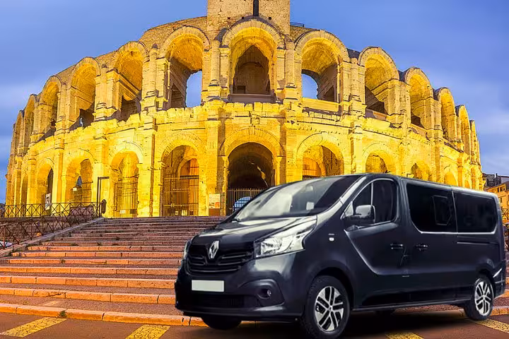 Private transfer Marseille to Arles van parked by Arles Roman Amphitheatre, comfortable Provence transport