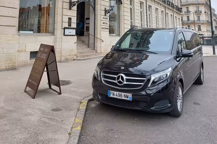 Black Mercedes-Benz V-Class van parked outside Grand Hotel La Cloche in France