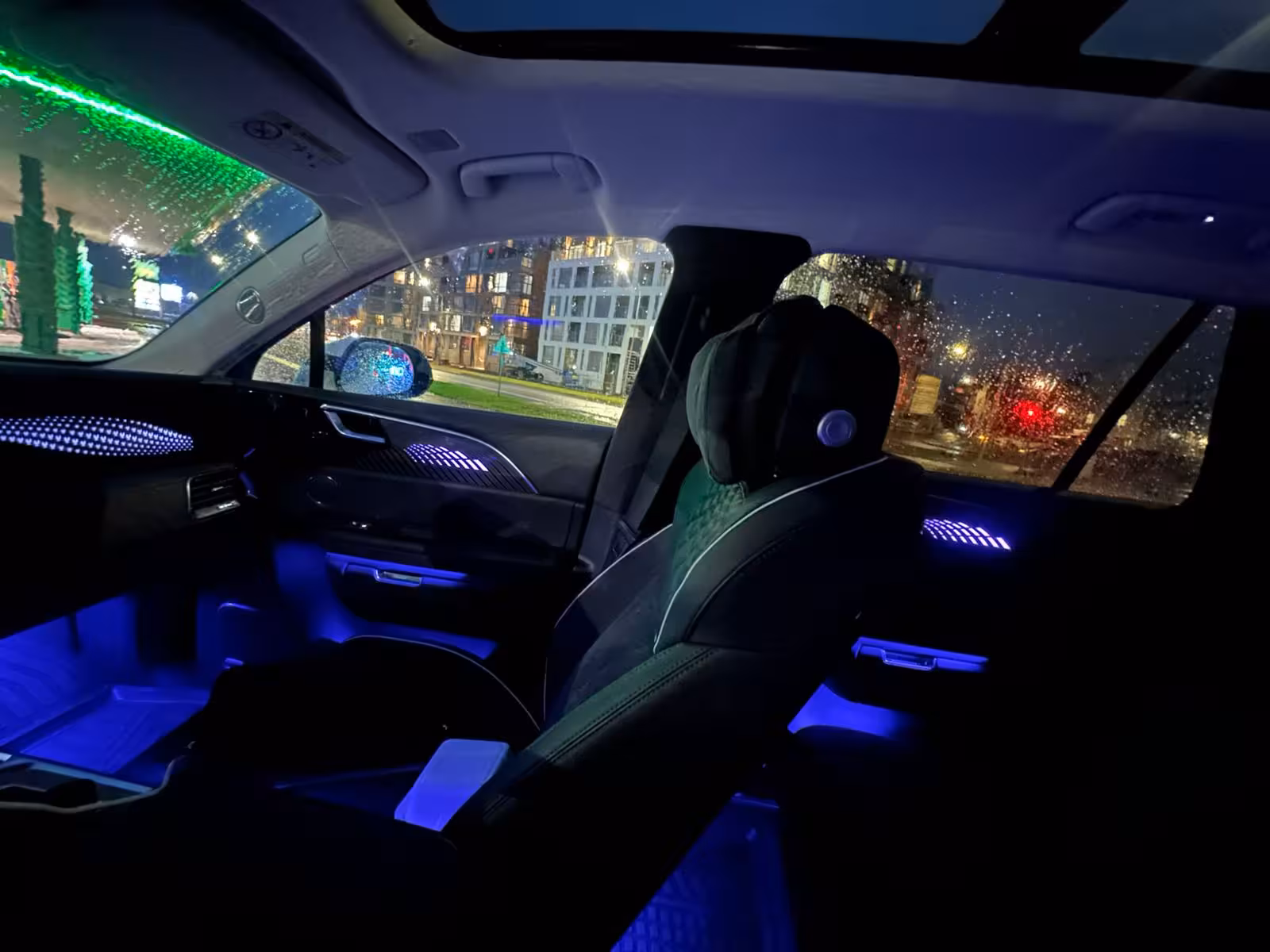 Luxury private transfer car interior with blue ambient lighting at night in Reykjavik
