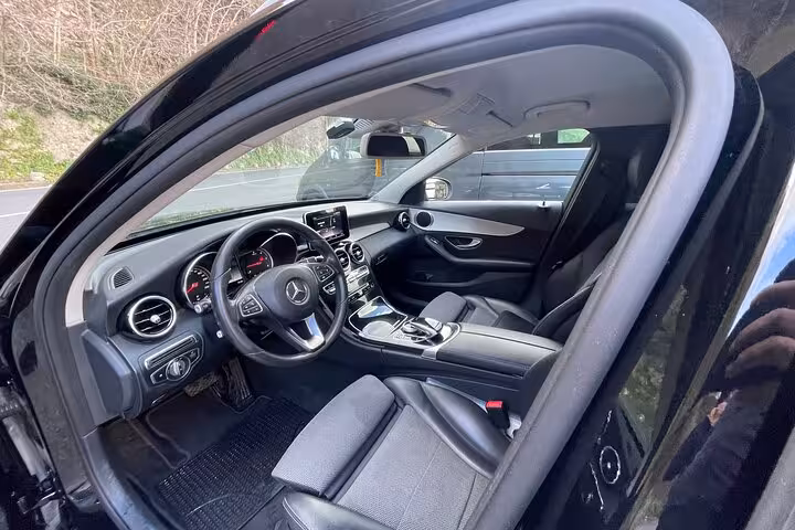 Elegant black car interior showcasing premium features for a seamless private transfer from Rome to Amalfi Coast.