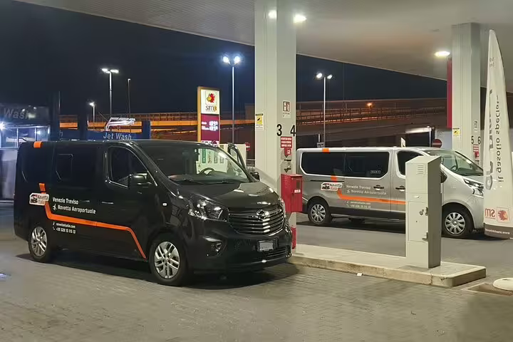 Private transfer vans at airport fuel station ready for Roatan RTB airport to Roatan hotel transport