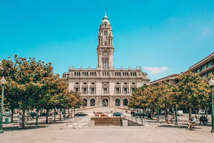 Historic city center with a grand architectural building, surrounded by lush trees, perfect for a private tuk-tuk tour excursion.