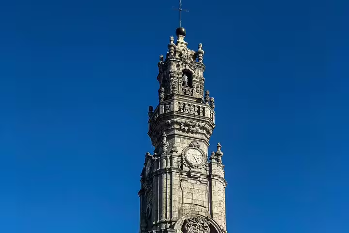 Historic clock tower against a clear blue sky, featured in a private tuk-tuk tour of the city's vibrant historic center.