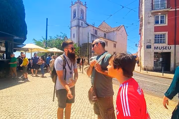Travelers meeting in Lisbon’s Belém area near a church, a highlight of a 4-hour private Tuk Tuk tour