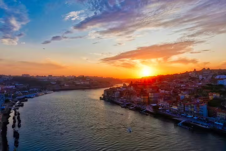 Stunning sunset view over the Douro River in Porto, perfect backdrop for a private TukTuk tour exploring Portugal's vibrant city.