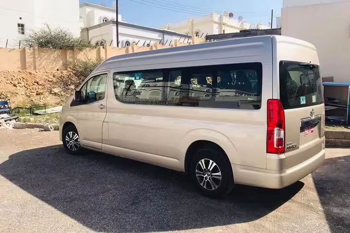 Spacious private van ready for transfer from Muscat to Wadi Shab, offering comfortable travel for small groups.