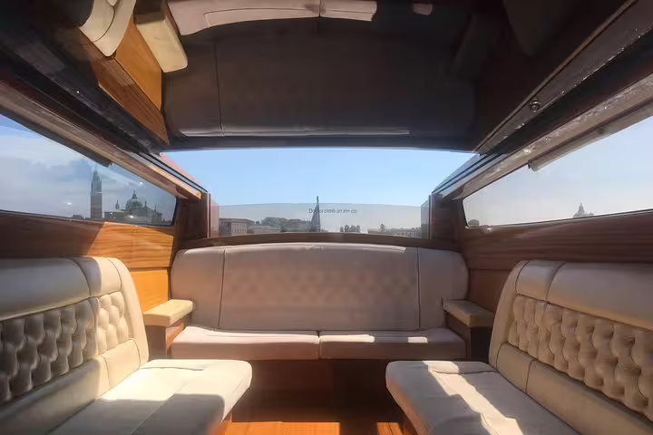 Luxurious interior of a private water taxi in Venice, offering a comfortable transfer to VCE airport.