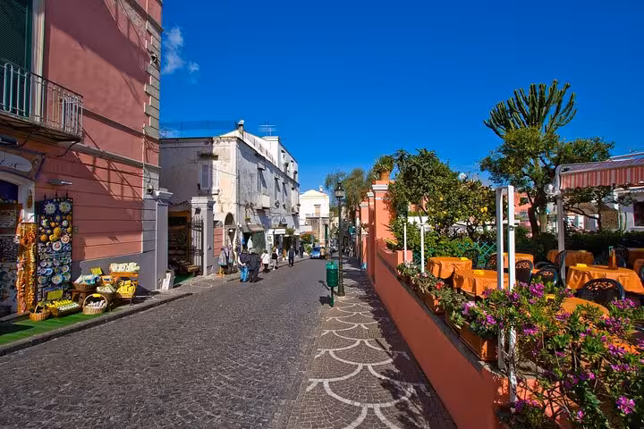 Charming street in Procida lined with colorful buildings and outdoor cafes, ideal for a leisurely exploration during the tour.