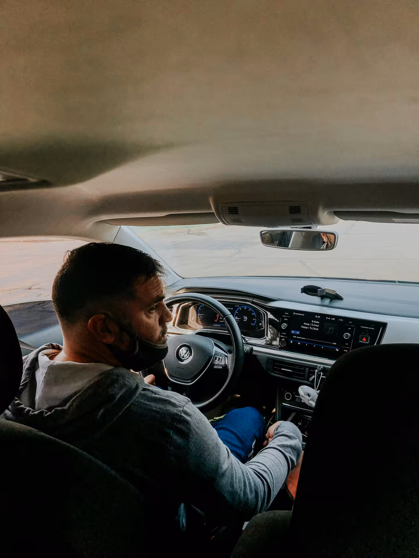 Professional chauffeur in modern air-conditioned car offering comfortable private transfer service in Muscat, Oman