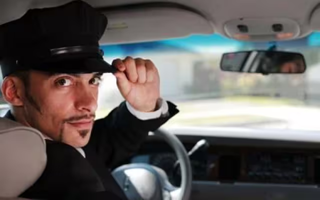 Professional chauffeur inside car greeting passengers for a comfortable, door-to-door private transfer to Naples city hotels