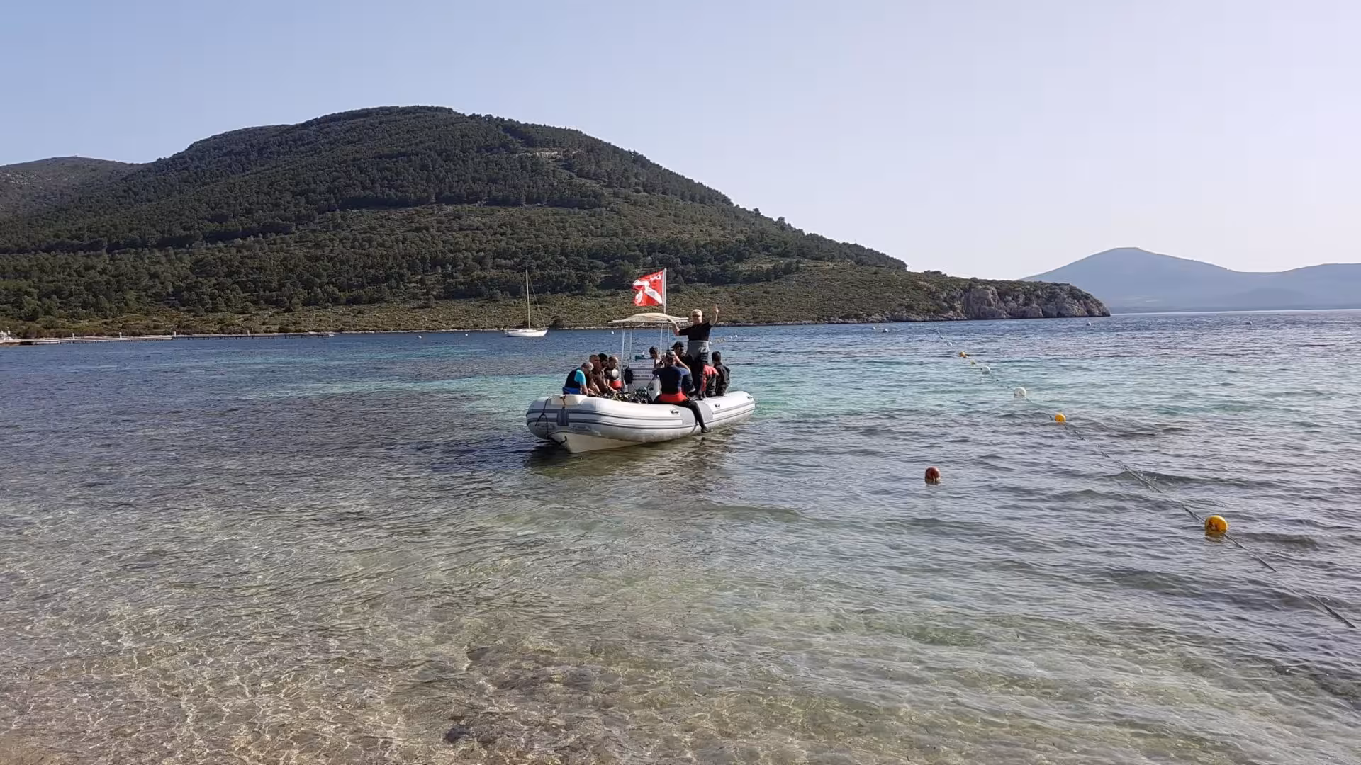 Divers on a boat prepare for a professional diving experience at Capo Caccia, Alghero's crystal-clear waters.