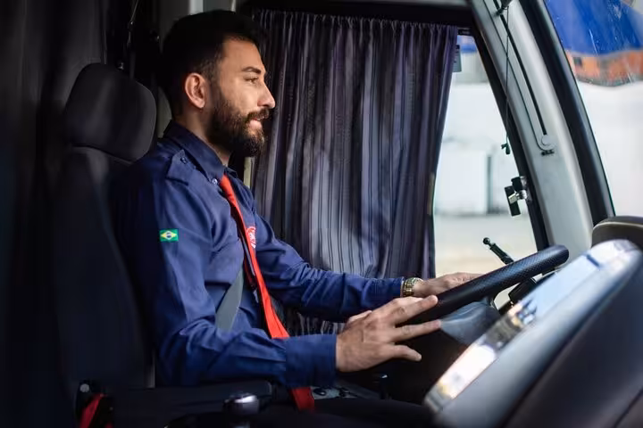 Professional driver inside an air-conditioned van, providing safe round-trip transfer to Beach Park Fortaleza